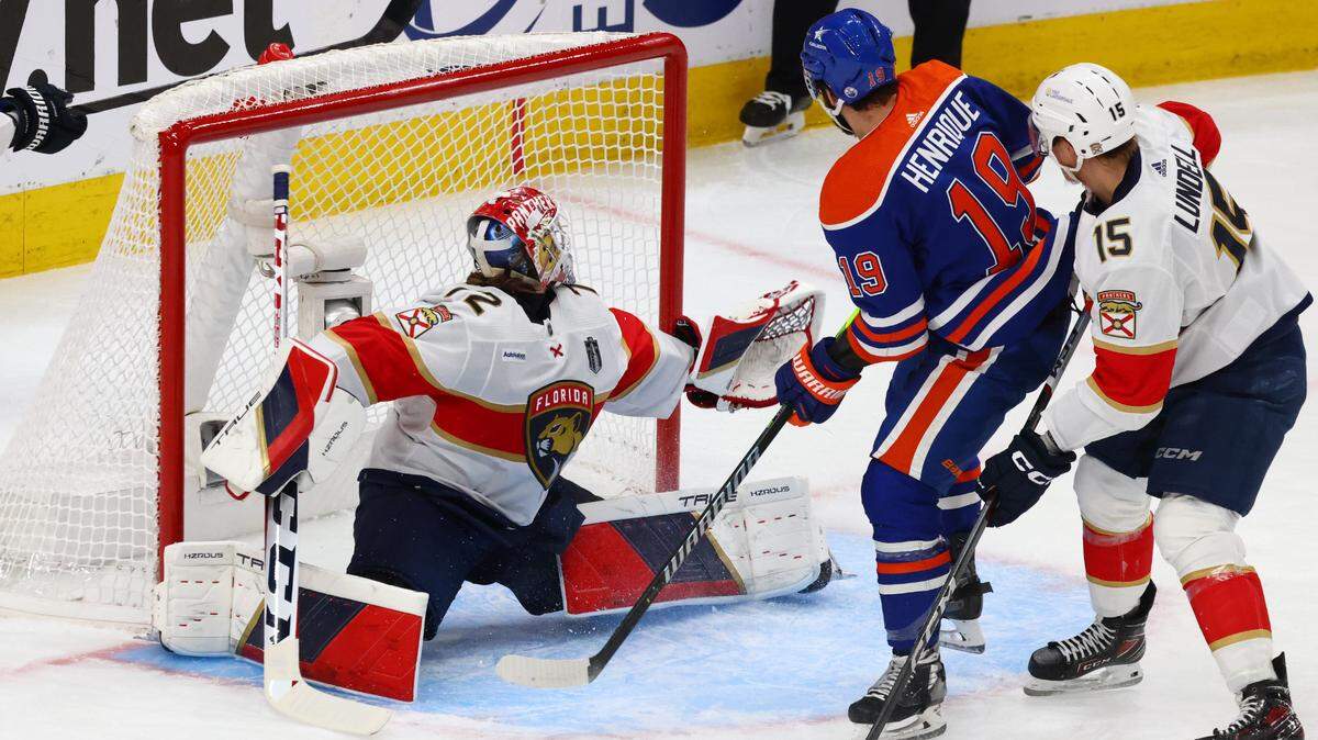 Jun 15, 2024; Edmonton, Alberta, CAN; Edmonton Oilers center Adam Henrique (19) scores a goal defended by Florida Panthers center Anton Lundell (15) and goaltender Sergei Bobrovsky (72) in the first period in game four of the 2024 Stanley Cup Final at Rogers Place.