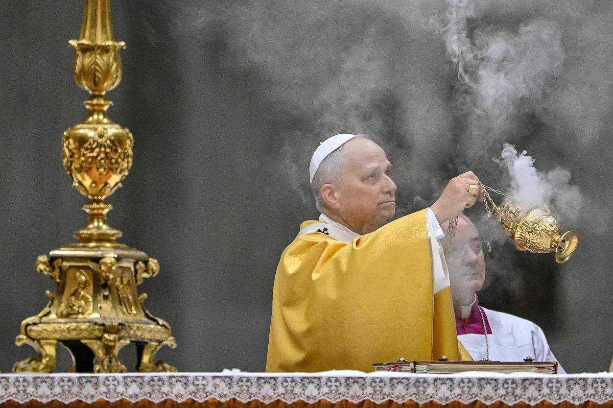 Pope Leo XIV holds an incent burner as he performs the Christmas Eve mass at St Peter's Basilica in the Vatican on December 24, 2025.