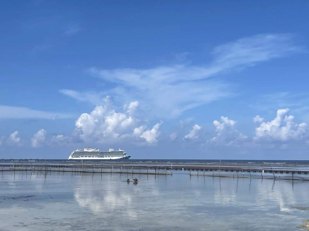 A cruise ship near Mahahual, where clear waters and coral reefs lie at the center of a growing debate over large-scale tourism, environmental limits and the town’s future.