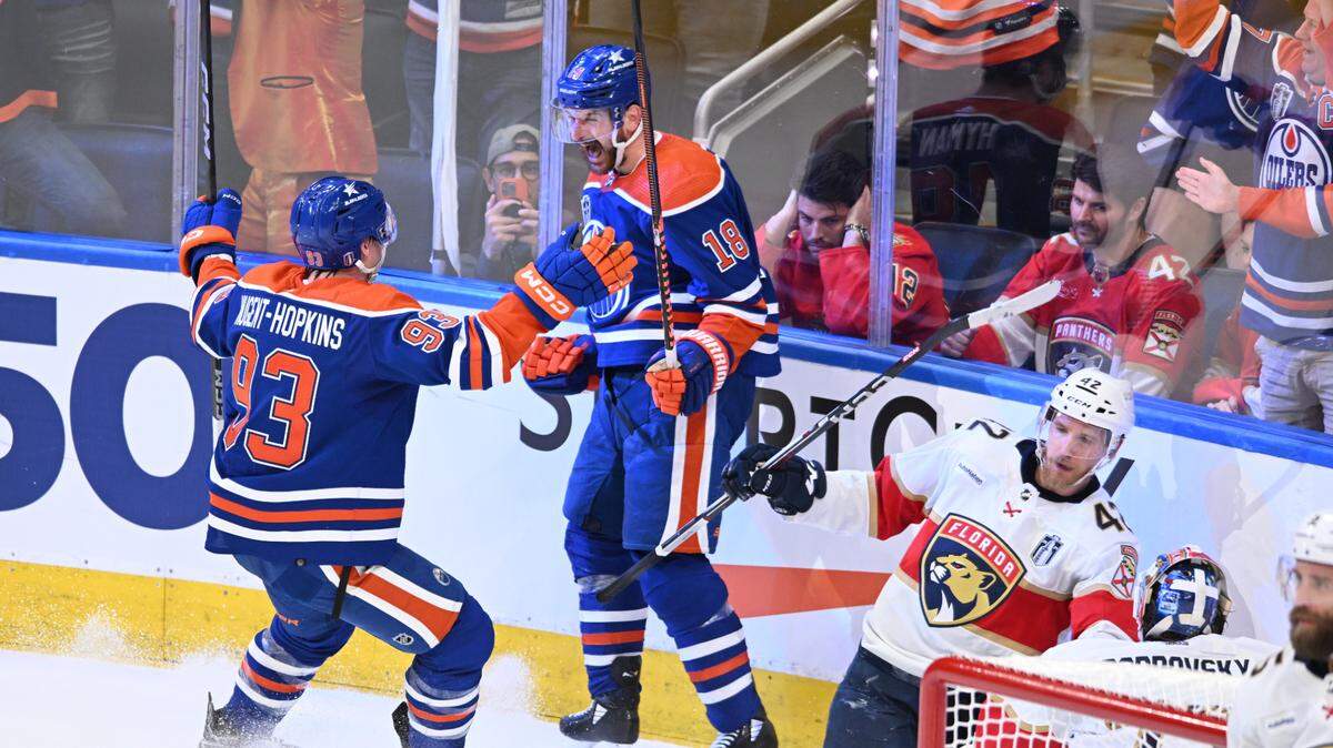 June 21, 2024; Edmonton, Alberta, CAN; Edmonton Oilers left wing Zach Hyman (18) celebrates with center Ryan Nugent-Hopkins (93) after scoring a goal against the Florida Panthers in the second period in game six of the 2024 Stanley Cup Final at Rogers Place. Mandatory Credit: Walter Tychnowicz-USA TODAY Sports