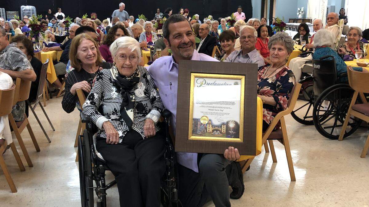 Hialeah Councilman Carl Zogby presents Maude Harris a proclamation plaque Aug. 31 to recognize her 111th birthday two weeks earlier.