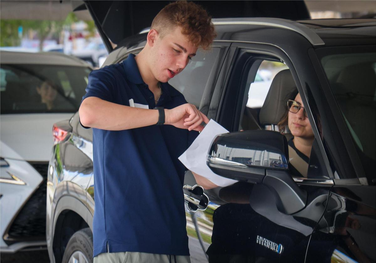 David Marcovitz, 17, left, shares delivery instructions as several Broward high school volunteers sorted, stocked, and packed kosher, non-perishable food items for a Passover meal distribution event organized by the Dorit & Ben J. Genet Cupboard in Broward County.