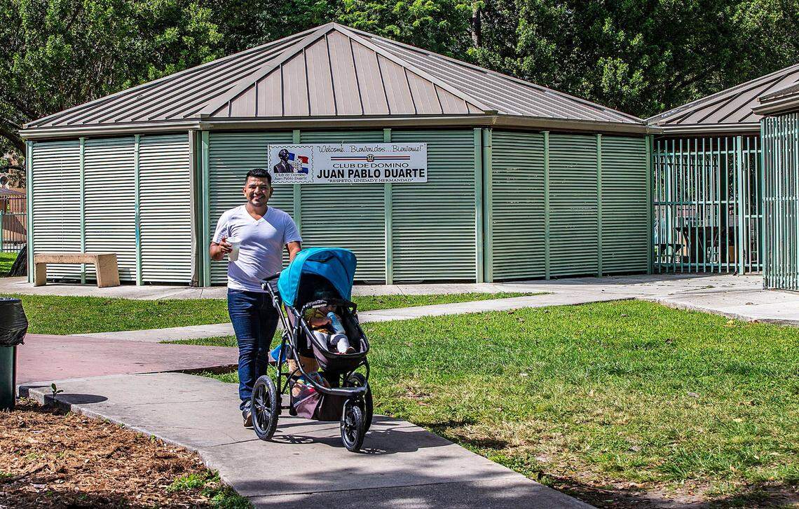 Jorge Adrian Suazo take a walk with his daughter Dircia Adriana at the Juan Pablo Duarte Park, located in an area known as Little Santo Domingo in Allapattah, on Sunday October 30, 2022.