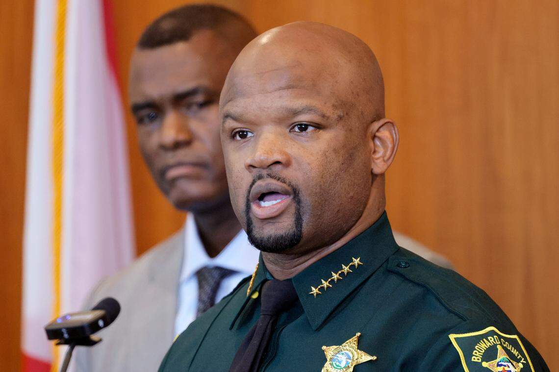 Broward Sheriff Gregory Tony speaks during a news conference at the Broward Sheriff’s Office Public Safety Complex in Fort Lauderdale on Thursday, Oct. 12, 2023, as U.S. Attorney for the Southern District of Florida Markenzy Lapointe looks on. 17 members of BSO have been charged with PPP fraud.