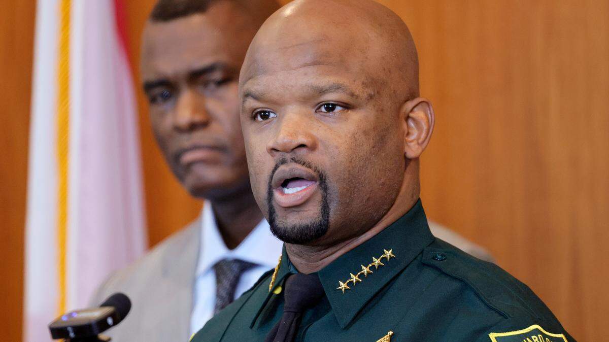 Broward Sheriff Gregory Tony speaks during a news conference at the Broward Sheriff’s Office Public Safety Complex in Fort Lauderdale on Thursday, Oct. 12, 2023, as U.S. Attorney for the Southern District of Florida Markenzy Lapointe looks on. 17 members of BSO have been charged with PPP fraud.