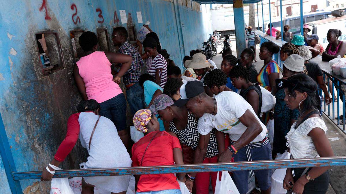 People gather outside the National Penitentiary for their turn to deliver food to their jailed relatives in downtown Port-au-Prince, Haiti, Thursday, June 1, 2023.