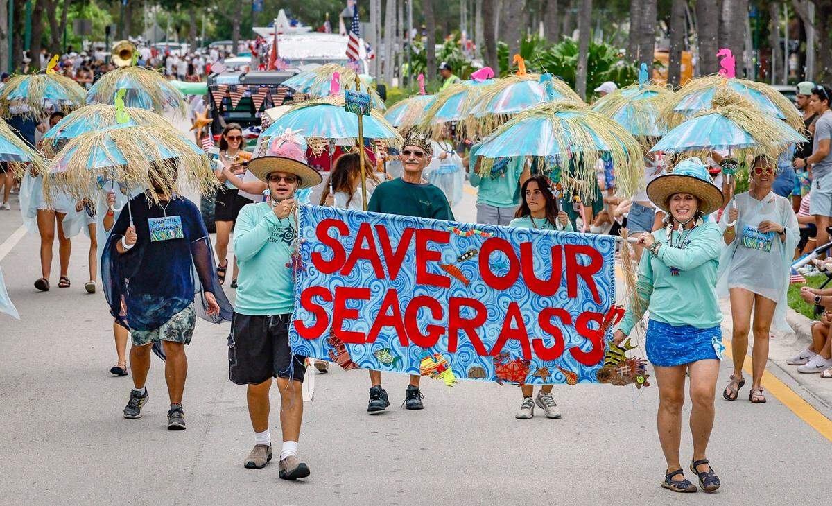 Biscayne Nature Center members display Save Our Seagrass along Crandon Boulevard as residents, family and friends celebrate Independence Day during the 66th Annual Key Biscayne Fourth of July Parade on Key Biscayne, Florida on Friday, July 4, 2025.