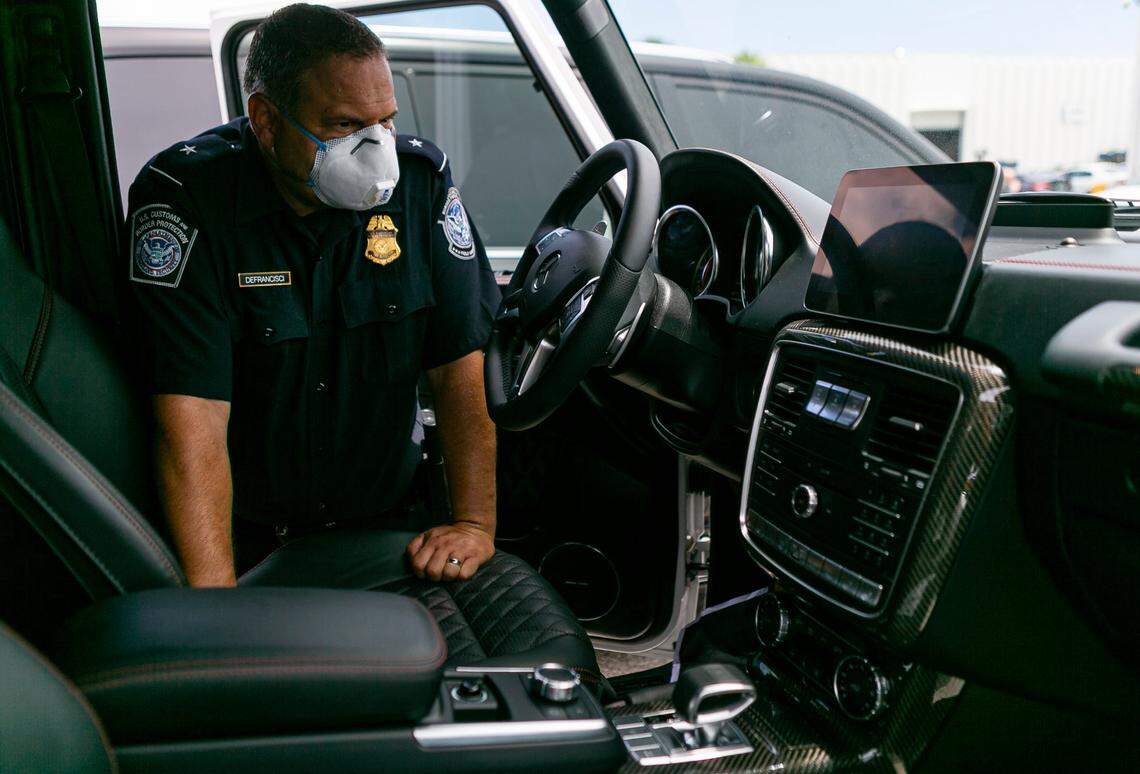 Dylan DeFrancisci, port director for U.S. Customs and Border Protection, looks at more than 80 vehicles seized by Homeland Security Investigations at Port Everglades on Tuesday, July 7, 2020. The vehicles, worth $3.2 million, were being shipped from Port Everglades to Venezuela. The cars, allegedly bought by a ring associated with the government of Venezuelan President Nicolas Maduro, were intercepted by Customs and Border Protection.