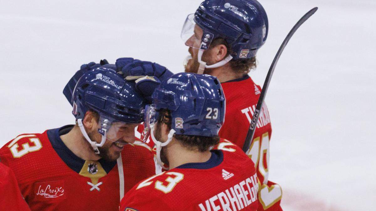 Florida Panthers center Carter Verhaeghe (23) congratulates Florida Panthers center Sam Reinhart (13) on the winning goal against the New York Rangers during overtime of Game 4 of the Eastern Conference finals of the NHL hockey Stanley Cup playoffs at the Amerant Bank Arena on Tuesday, May 28, 2024, in Sunrise, Fla.