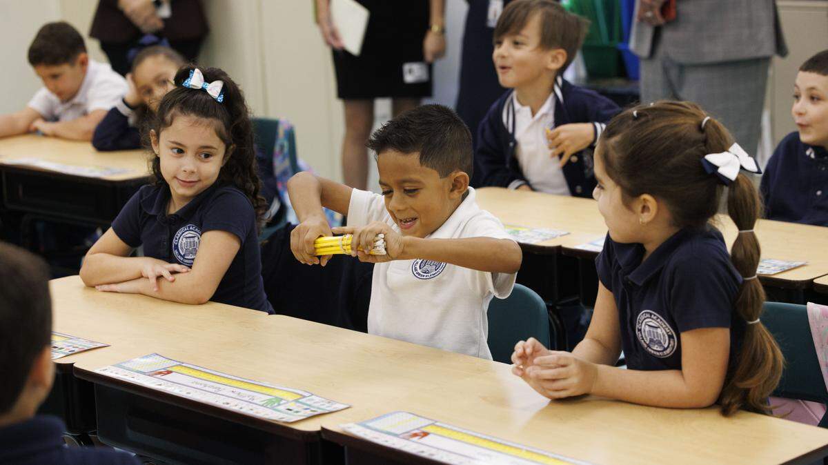 Kindergarten students in the classical education classroom of Ms. Geraldine Cameron participate in a lesson during the school day on Tuesday, Nov. 18, 2025, at Village Green Elementary School in Miami, Fla. Cameron has helped to implement a classical education system at the school that originates from Ancient Greece meant to cultivate critical thinking and virtues in its students, and it disconnects them from technology to focus on active listening.