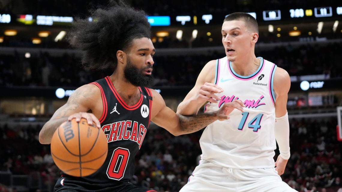Miami Heat guard Tyler Herro (14) defends Chicago Bulls guard Coby White (0) during the first quarter at United Center.