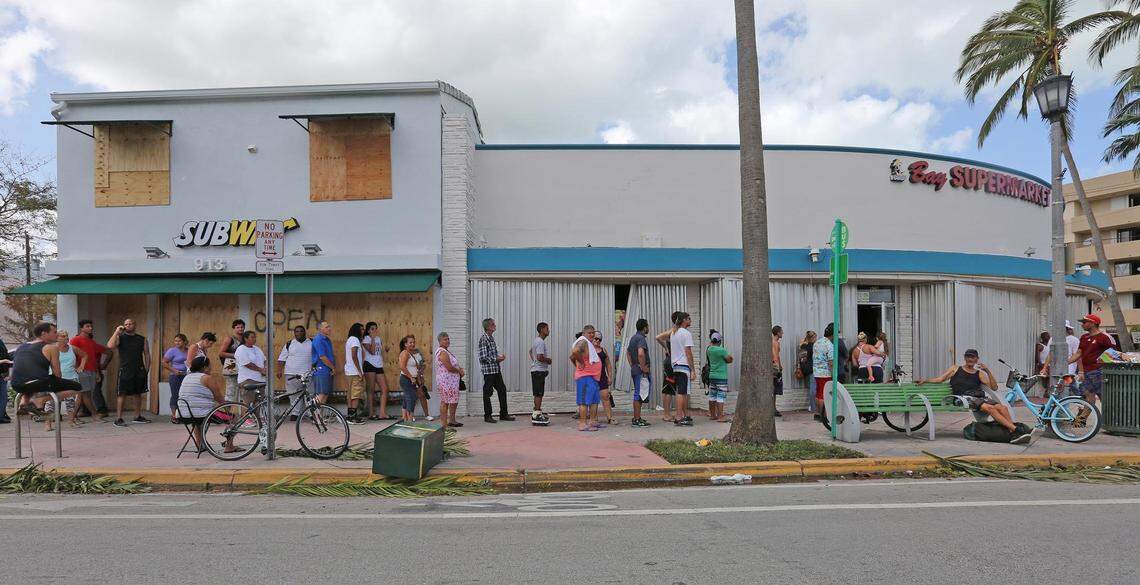 About thirty five people line up to purchase food at Bay Supermarket in Normandy Isle in Miami Beach on on Sept. 11, 2017