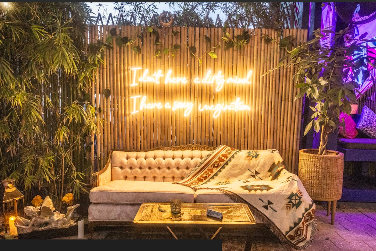 A sign above a couch at Osmio Lounge says, ‘I don’t have a dirty mind. I have a sexy imagination.’