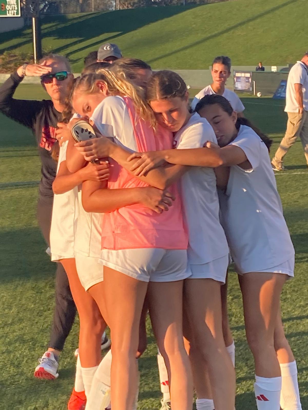 Cardinal Gibbons’ girls’ soccer players console each other after their 4-0 loss to Orlando Lake Highland Prep in a Class 3A state semifinal on Tuesday at Spec Martin Stadium in DeLand, Fla.