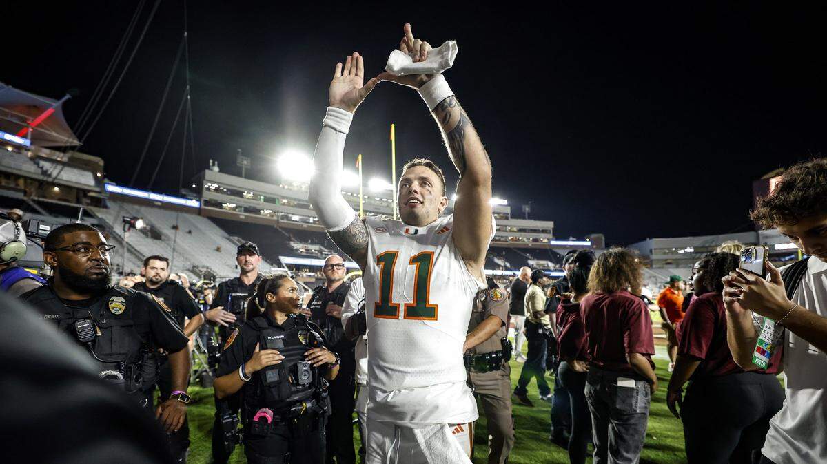 Miami Hurricanes quarterback Carson Beck (11) flashes the U after the Hurricanes defeat the Florida State Seminoles during their NCAA game at Doak Campbell Stadium in Tallahassee, Florida, on Saturday, October 4, 2025.