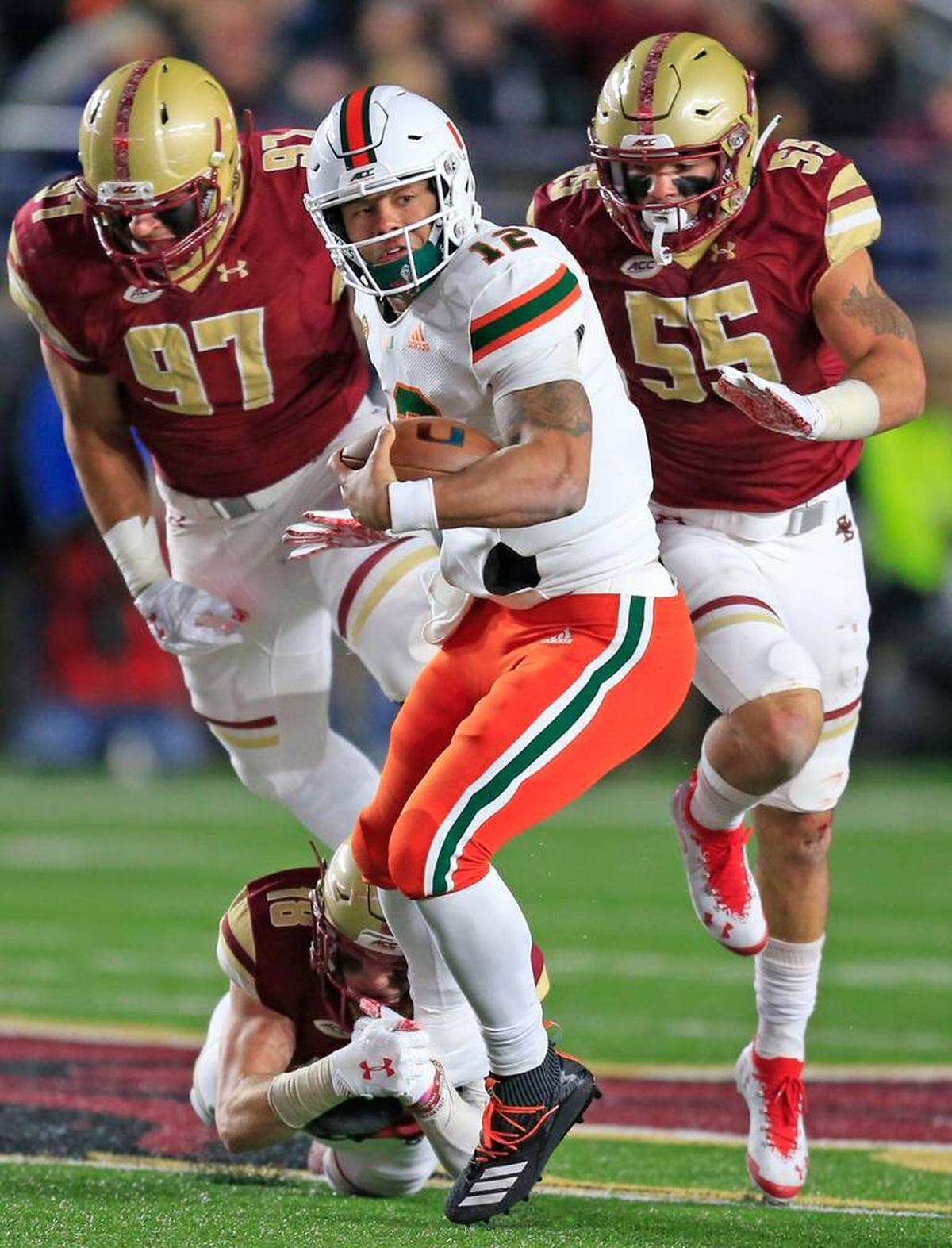 Miami Hurricanes quarterback Malik Rosier (12) runs for a first down in the second quarter as the University of Miami plays Boston College at Alumni Stadium in Chestnut Hill on Friday, October 26, 2018.