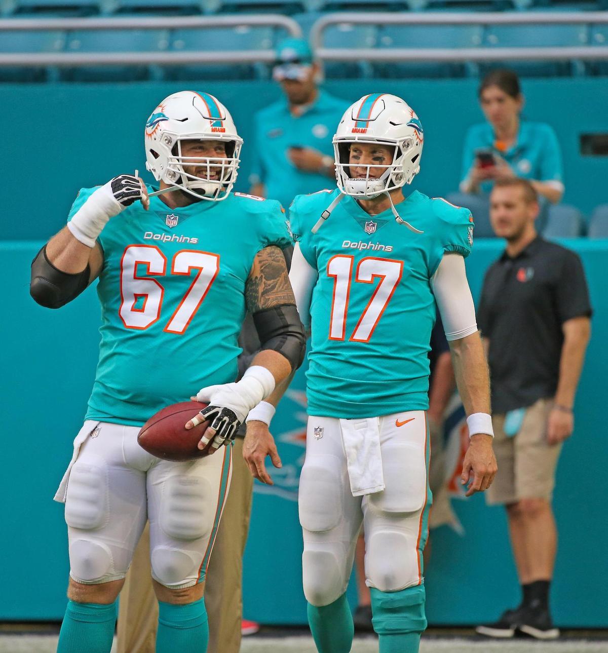 Miami Dolphins quarterback Ryan Tannehill #17 greets center Daniel Kilgore #67 practice before the start of an NFL football game  against the Tampa Bay Buccaneers at Hard Rock Stadium on Thursday, August. 9, 2018, in Miami Gardens..