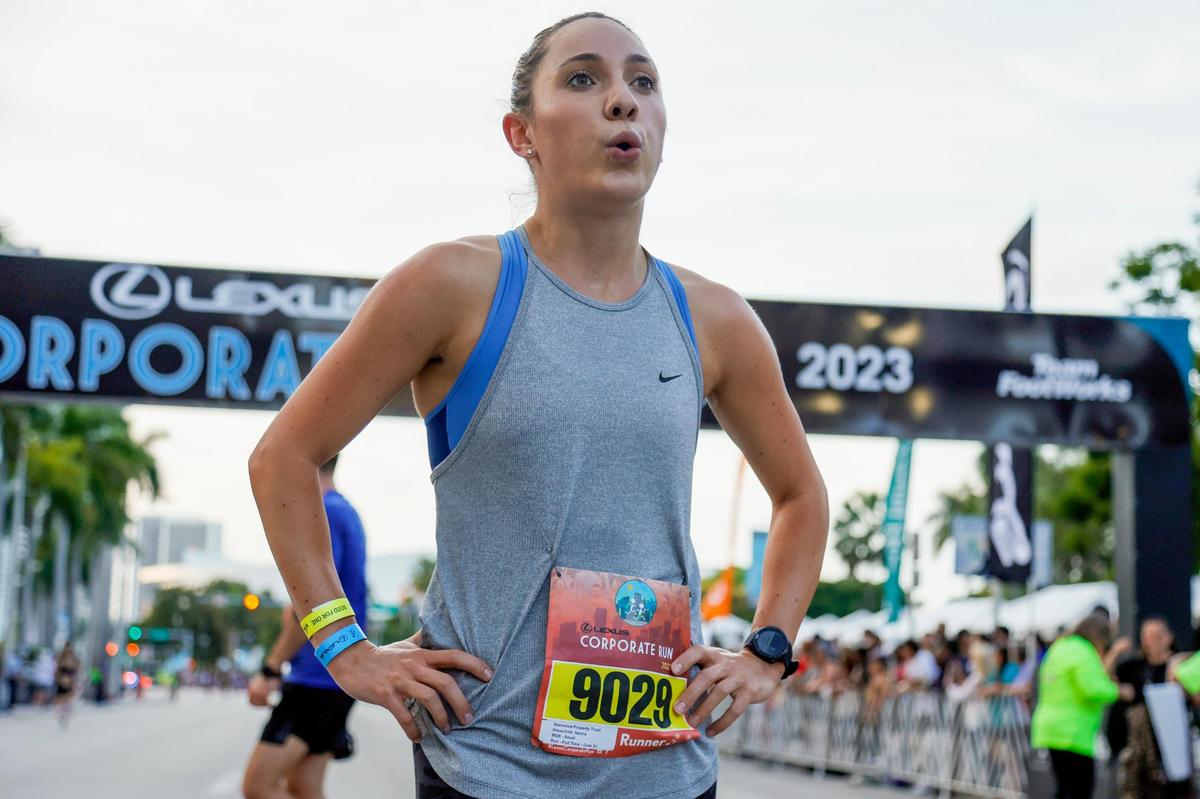 Hanna Hauschild from Starwood Property Trust reacts as the first woman to cross finish line during the Lexus Corporate Run in Downtown Miami on Thursday, April 27, 2023.