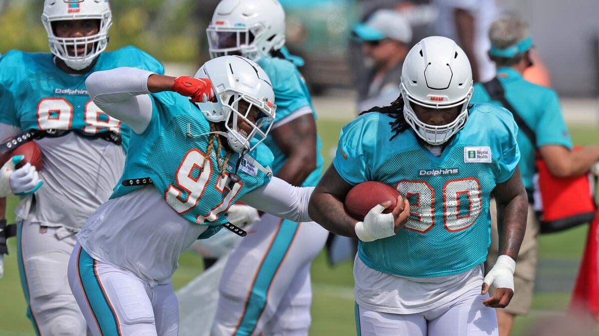 Miami Dolphins defensive end Jabaal Sheard (97) and Dolphins defensive tackle John Jenkins (90) does drills during practice at Baptist Health Training Complex in Hard Rock Stadium on Wednesday, October 6, 2021 in Miami Gardens, Florida, in preparation for their game against the Tampa Bay Buccaneers at Raymond James Stadium, on Sunday, October 10.
