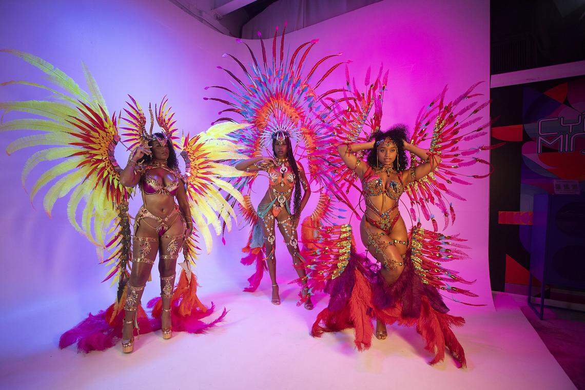 Models Chelby Elizabeth, Joanna Miracle and Kathryn Celeste pose in designer Lila Nikole's carnival costumes, decorated with gemstones, feathers and bright colors, during a photo shoot at Nikole's studio in North Miami Beach, Fla., Wednesday, Oct. 1, 2025.
