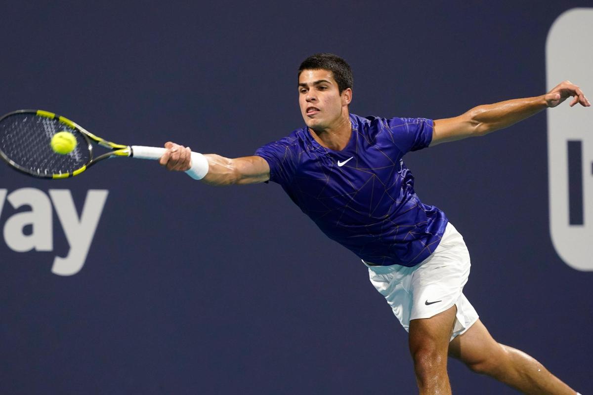 Carlos Alcaraz of Spain returns the ball to Stefanos Tsitsipas of Greece during the Miami Open tennis tournament, Tuesday, March 29, 2022, in Miami Gardens, Fla. (AP Photo/Marta Lavandier)