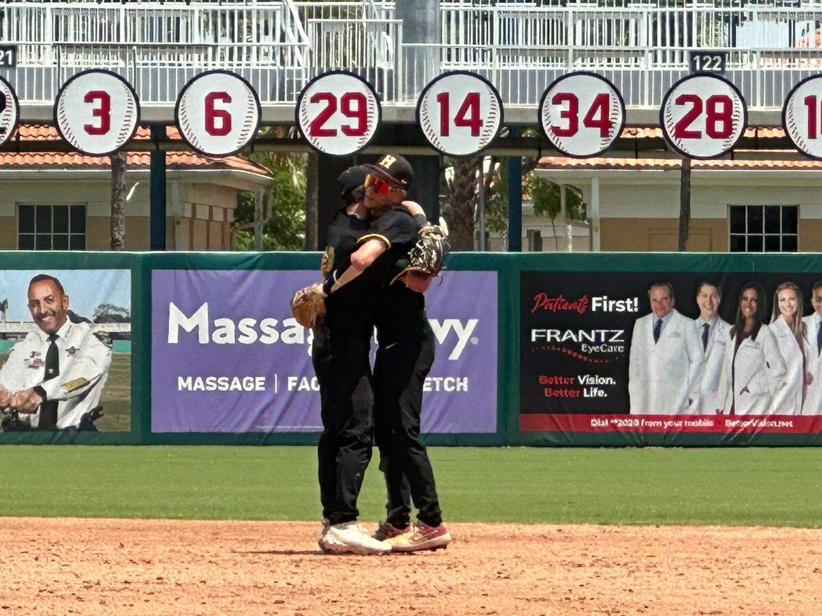 American Heritage teammates hug after the Patriots’ 5-2 win over Lake City Columbia in a Class 5A state baseball semifinal on Monday at Hammond Stadium in Fort Myers, Fla.