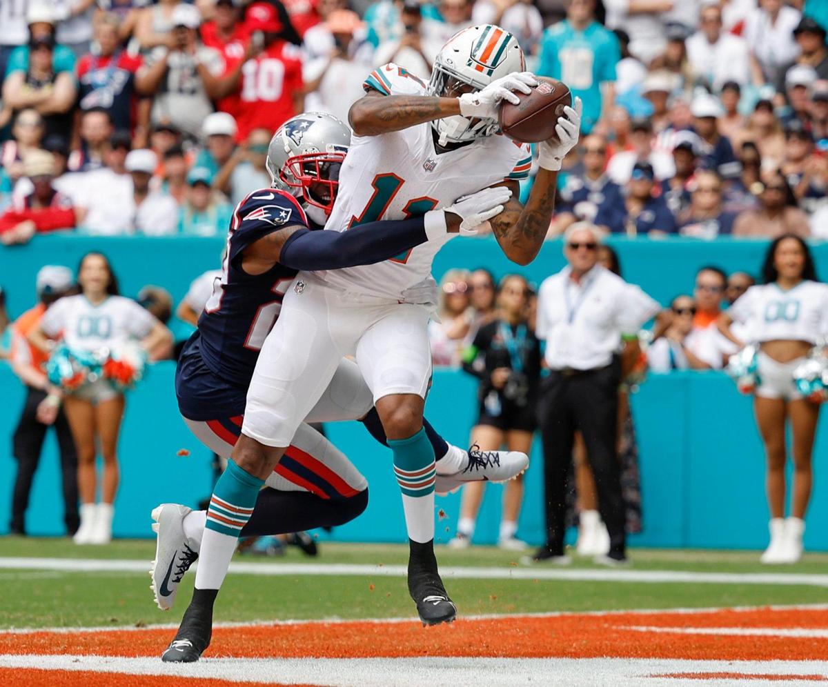 Miami Dolphins wide receiver Cedrick Wilson Jr. (11) scores in the second quarter as New England Patriots cornerback J.C. Jackson (29) fails to defend at Hard Rock Stadium in Miami Gardens on Sunday, October 29, 2023.