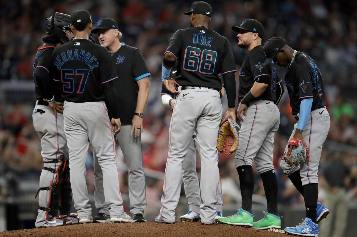 Miami Marlins pitcher Elieser Hernandez (57) meets with players and coaching staff in the fifth inning of a baseball game against the Atlanta Braves Saturday, Sept. 11, 2021, in Atlanta.