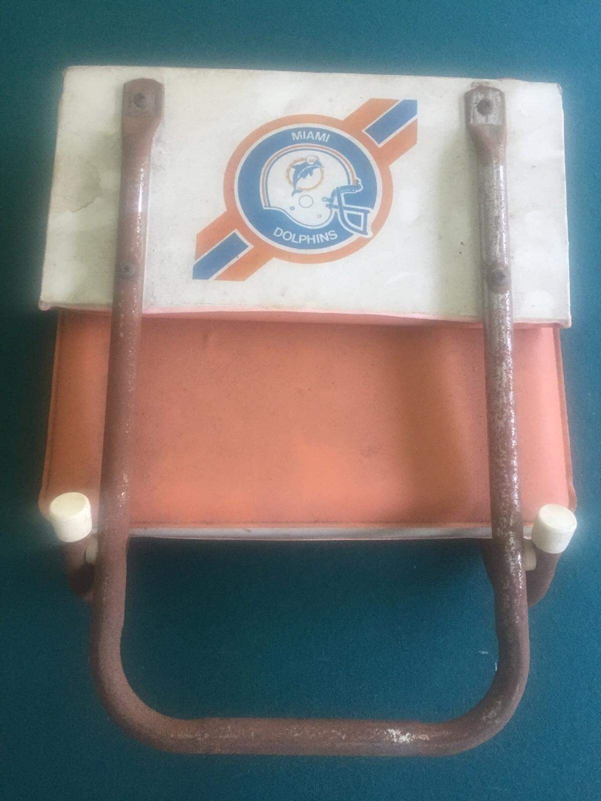 The rusted original Dolphins seat cushion in my garage to this day that I cannot bear to throw away.