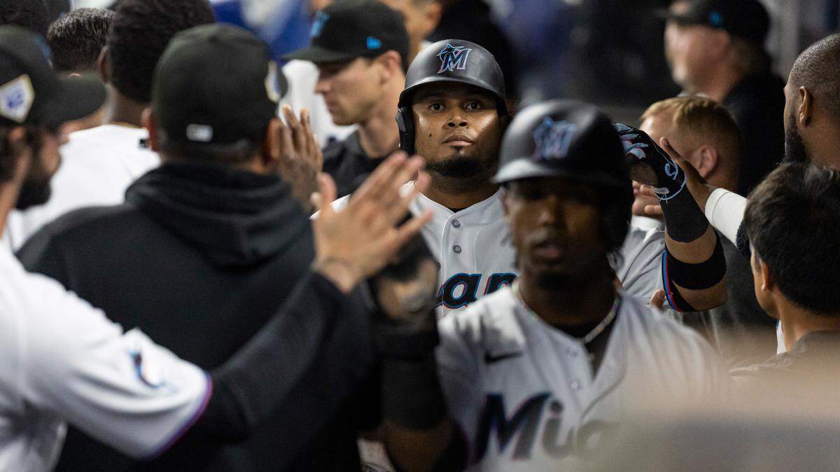 Miami Marlins second baseman Luis Arraez (42) and third baseman Jean Segura (42) celebrate after they scored a run against the Arizona Diamondbacks in the seventh inning of an MLB game at loanDepot park on Saturday, April 15, 2023, in Miami, Fla.