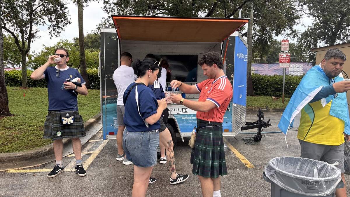 Fans gather at a Miami-Dade County hydration station outside. The county is working to keep people safe and cool at World Cup events amid the extreme heat.