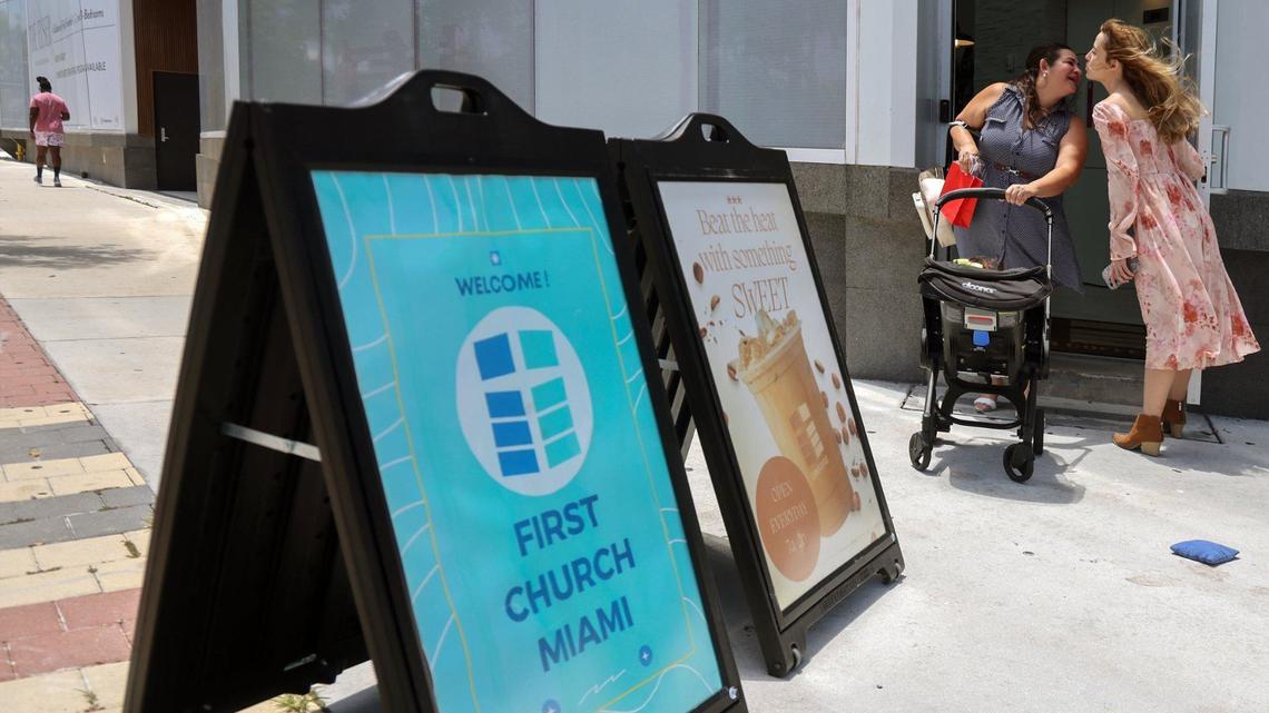 Lucy Nunez, left, bids farewell to Valeria Serra, right, as she exits Corner Coffee. The coffee shop occupies the first floor of the new building of the First United Methodist Church in downtown Miami.