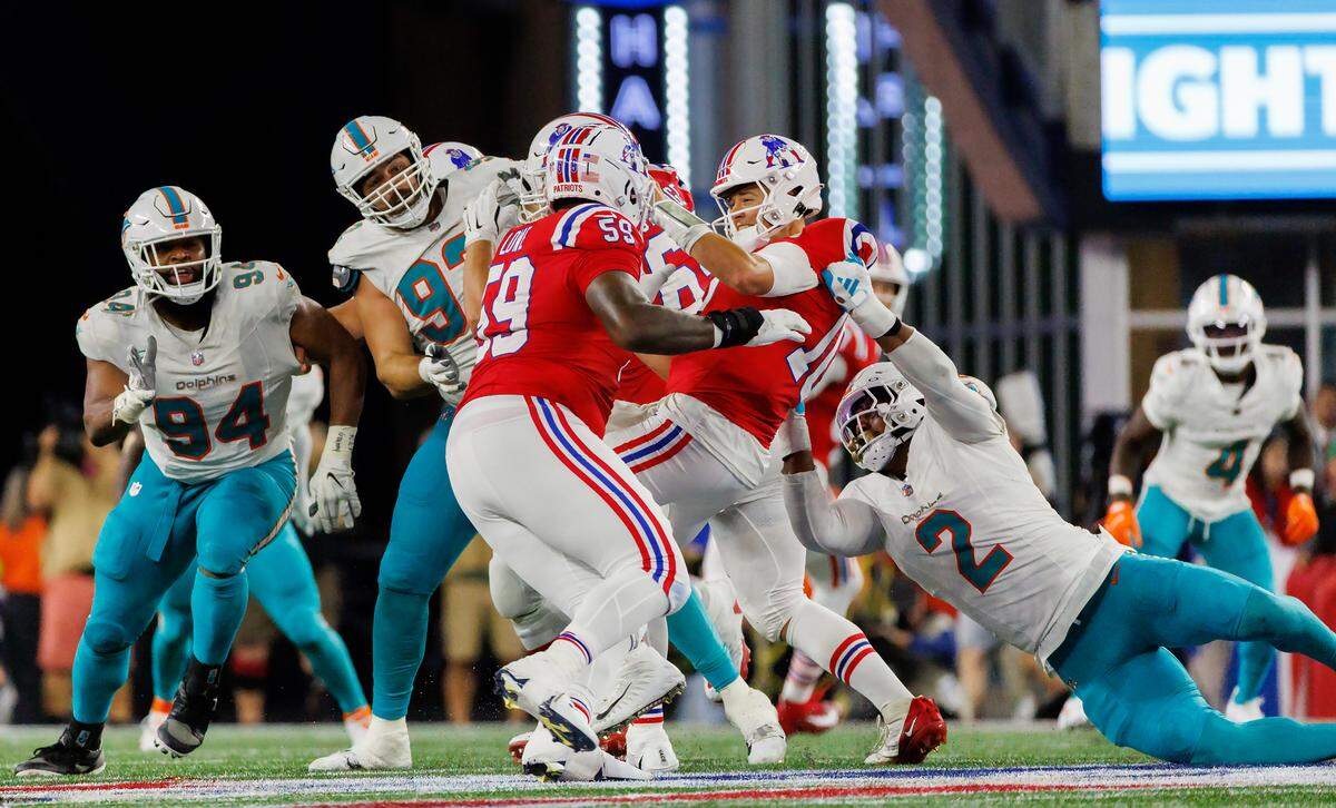 New England Patriots quarterback Mac Jones (10) is being sacked by Miami Dolphins linebacker Bradley Chubb (2) during fourth quarter of an NFL football game at Gillette Stadium on Sunday, Sept. 17, 2023 in Foxborough, MA.