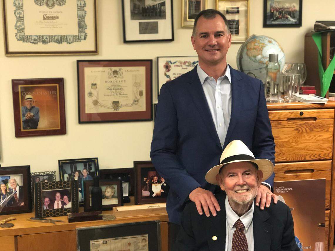 Chip Cassidy at his office at Florida International University with his son, Patrick, in a recent photo. His office will be kept as is, as a memorial to Cassidy, the hospitality college’s dean said.