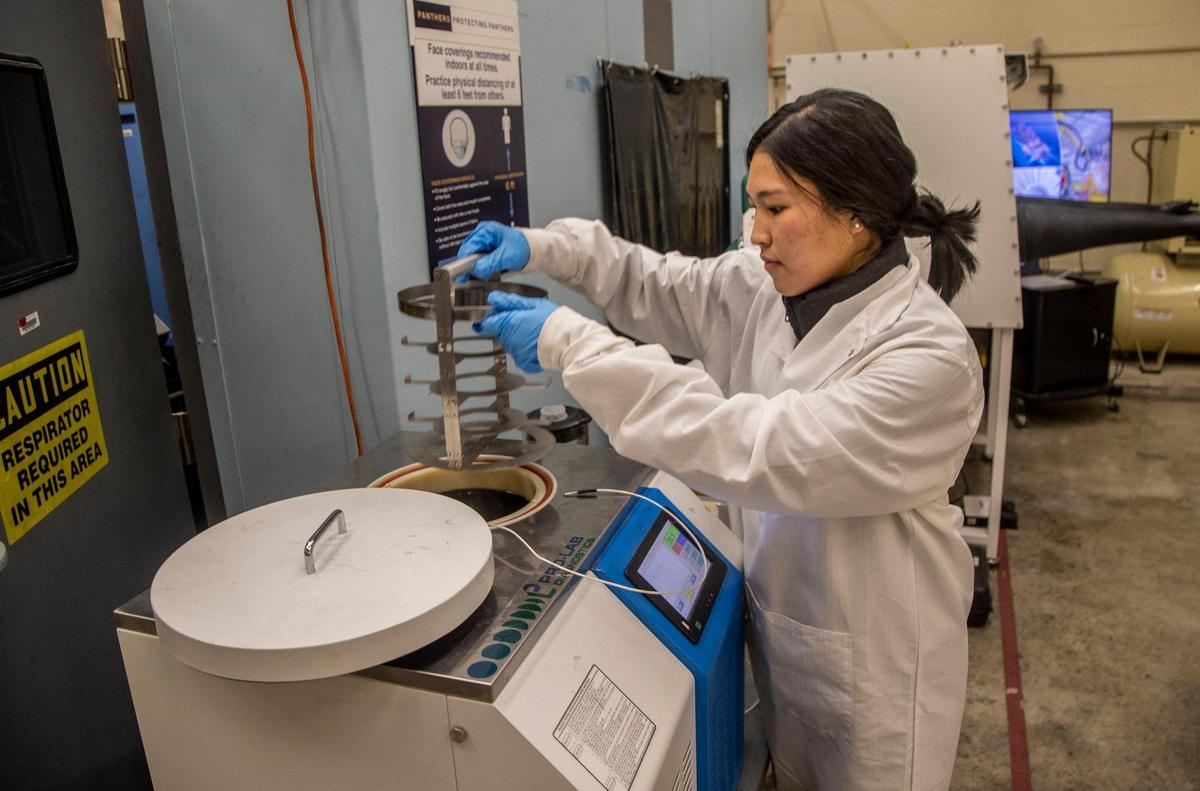 FIU graduate student Kazue Orizaka works at a machine used for Cold Spray and Rapid Deposition (ColRAD) research done at FIU’s College of Engineering & Computing.