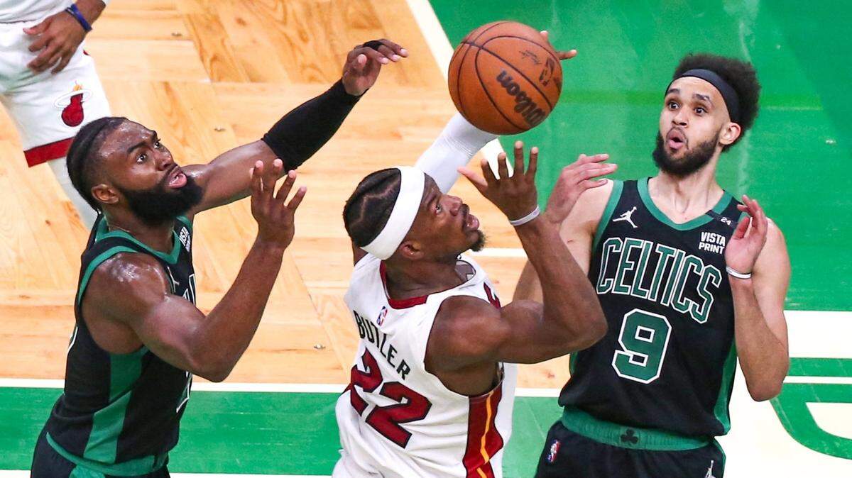 Miami Heat forward Jimmy Butler (22) battles for the ball as Boston Celtics guard Jaylen Brown (7) and guard Derrick White (9) defend during the second quarter of Game 6 of the NBA Eastern Conference Finals series at TD Garden in Boston, Massachusetts, on Friday, May 27, 2022