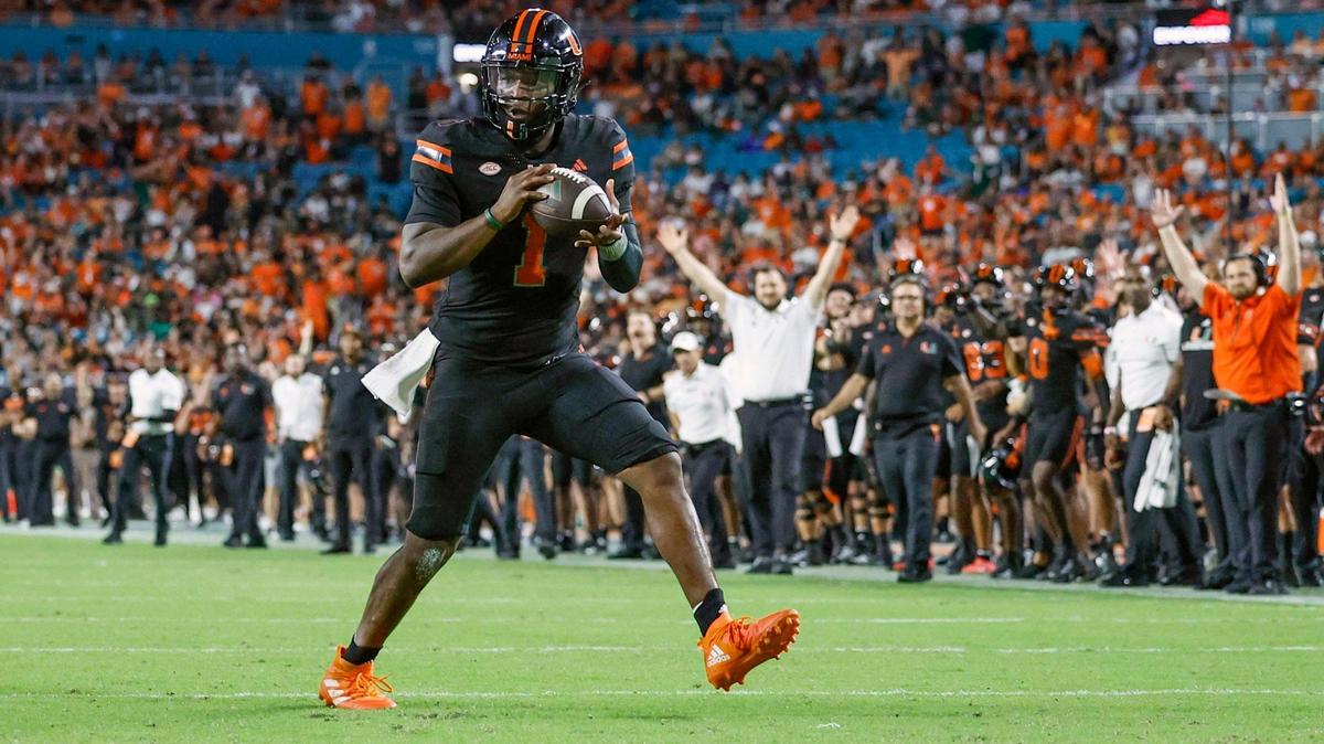 Miami Hurricanes quarterback Cam Ward (1) scores on a pass by tight end Elija Lofton (9) against the Florida State Seminoles in the second half during an NCAA football game at Hard Rock Stadium in Miami Garden, Florida on Saturday, October 26, 2024.
