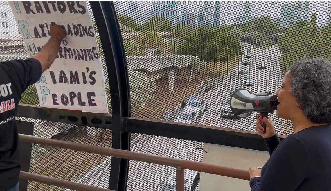 Yurina Gil speaks through a bullhorn during an anti-ICE protest from the Vizcaya pedestrian bridge in Coconut Grove Monday, Jan. 12, 2026. Gil, a Democrat, is a candidate in the November election for Florida’s 26th U.S. Congressional District against incumbent Rep. Mario Diaz-Balart, a Republican.&nbsp;