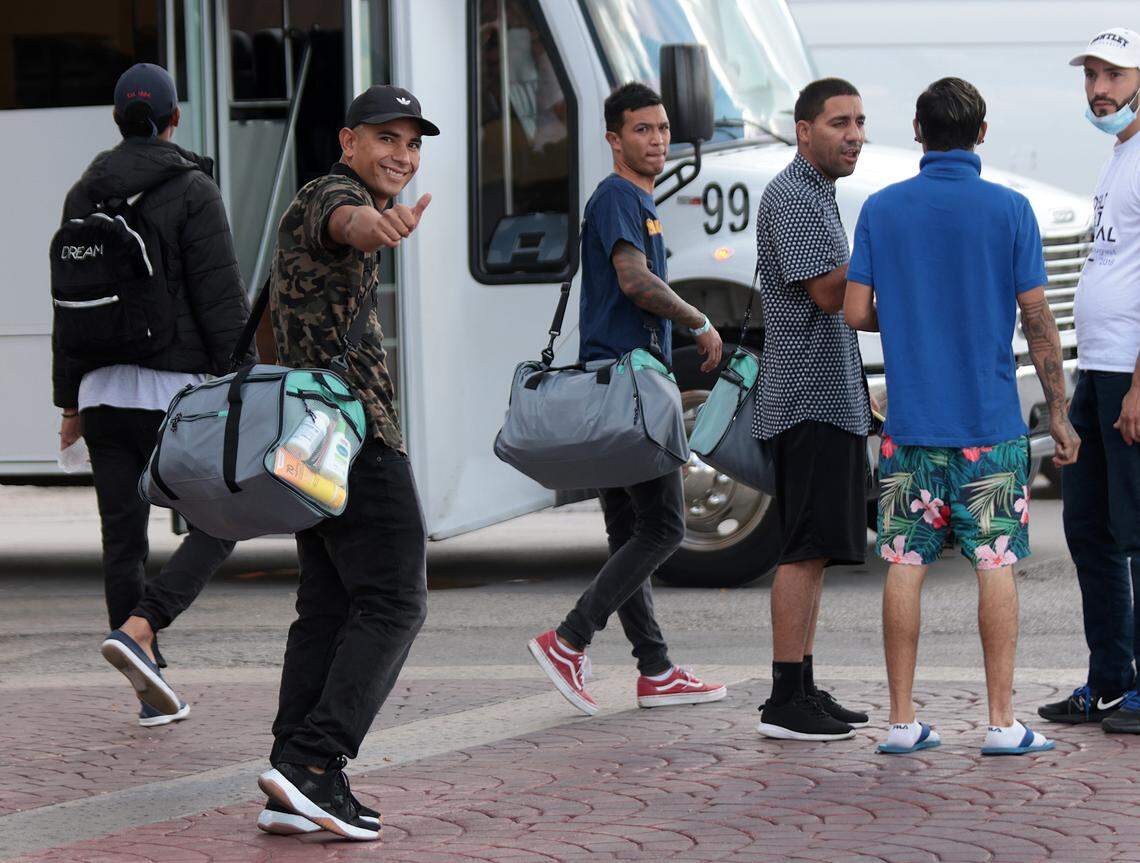 Jesús Guillén, second from the left, gives a thumb-up while boarding a bus outside a hotel in San Antonio on Sept. 20, where he stayed waiting for a Vertol-chartered flight that was eventually canceled. His duffel bag was purchased by the company and given to him in preparation for the flight.