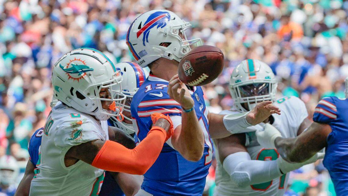 Buffalo Bills quarterback Josh Allen (17) loses the ball after getting hit by Miami Dolphins safety Jevon Holland (8) in the first quarter at Hard Rock Stadium in Miami Gardens on Sunday, September 25, 2022.
