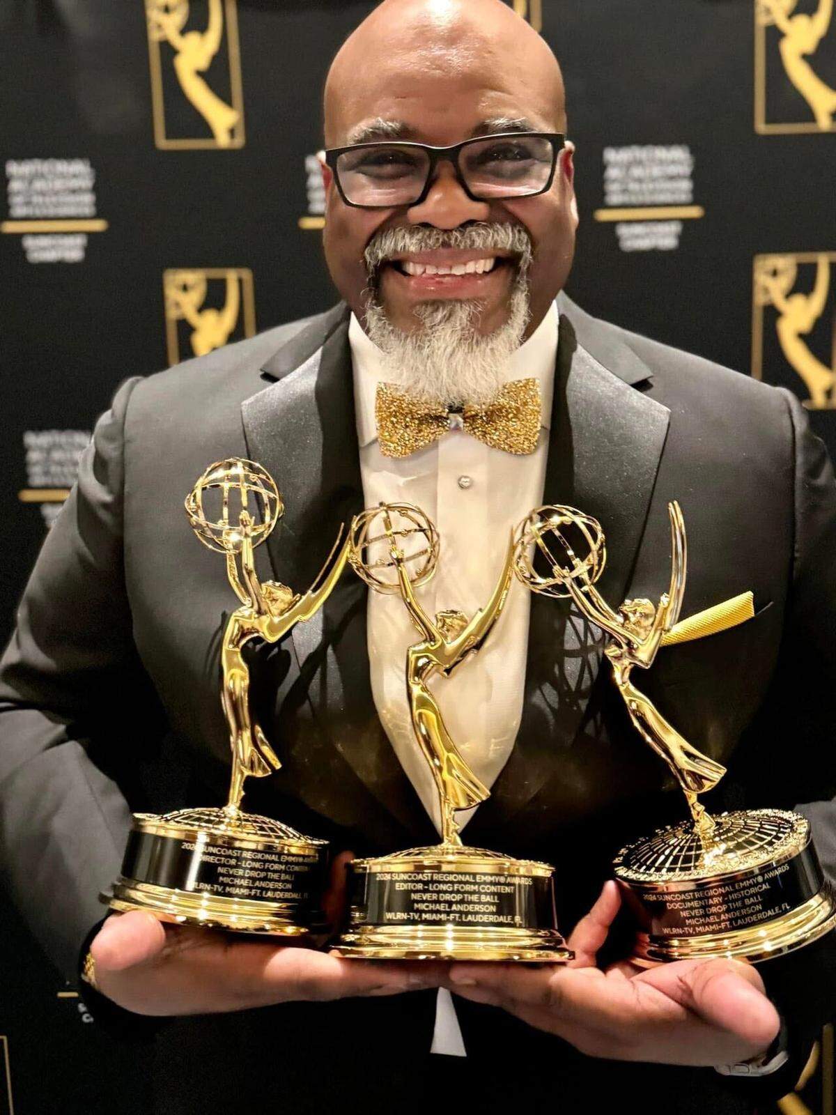 WLRN Senior Director for Production Services Michael Anderson holds two of three Suncoast Regional Emmy Awards for the WLRN original documentary, ‘Never Drop the Ball.’