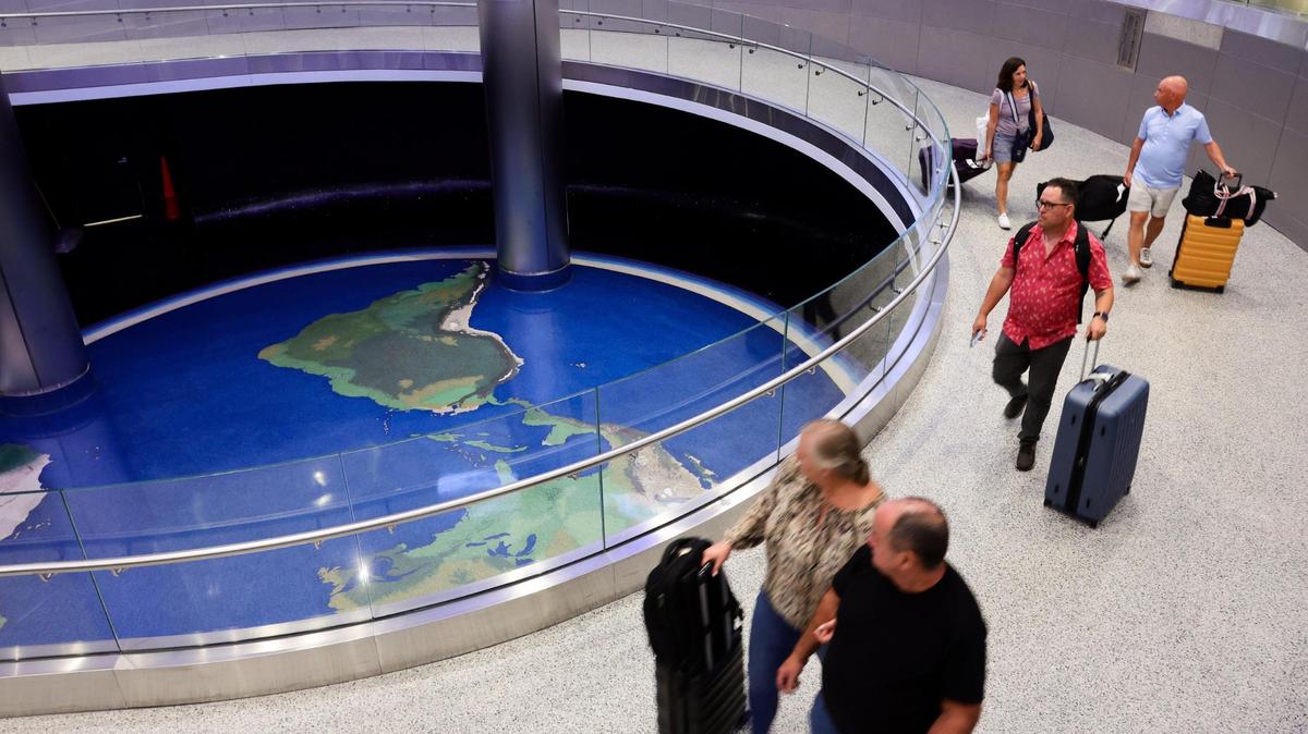 Travelers with their luggage arrive at at Miami International Airport in Miami, Florida, on Tuesday, November 12, 2024.