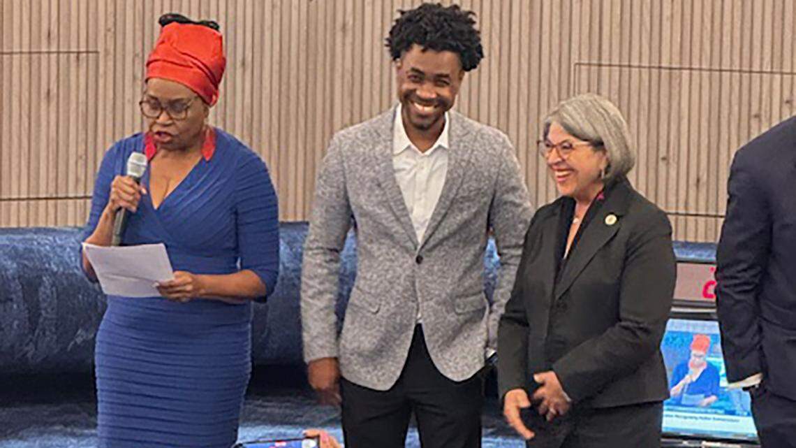 Miami-Dade County Commissioner Marleine Bastien, left, and Miami-Dade County Mayor Daniella Levine Cava, right, honor filmmaker Robenson Lauvince, center, who directed the Haitian film “July 7: Who Killed the President of Haiti?”