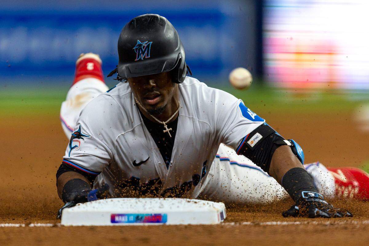 Miami Marlins base runner Jean Segura (9) slides into third base during the an MLB game against the Washington Nationals at loanDepot park in the Little Havana neighborhood of Miami, Florida, on Wednesday, May 17, 2023.
