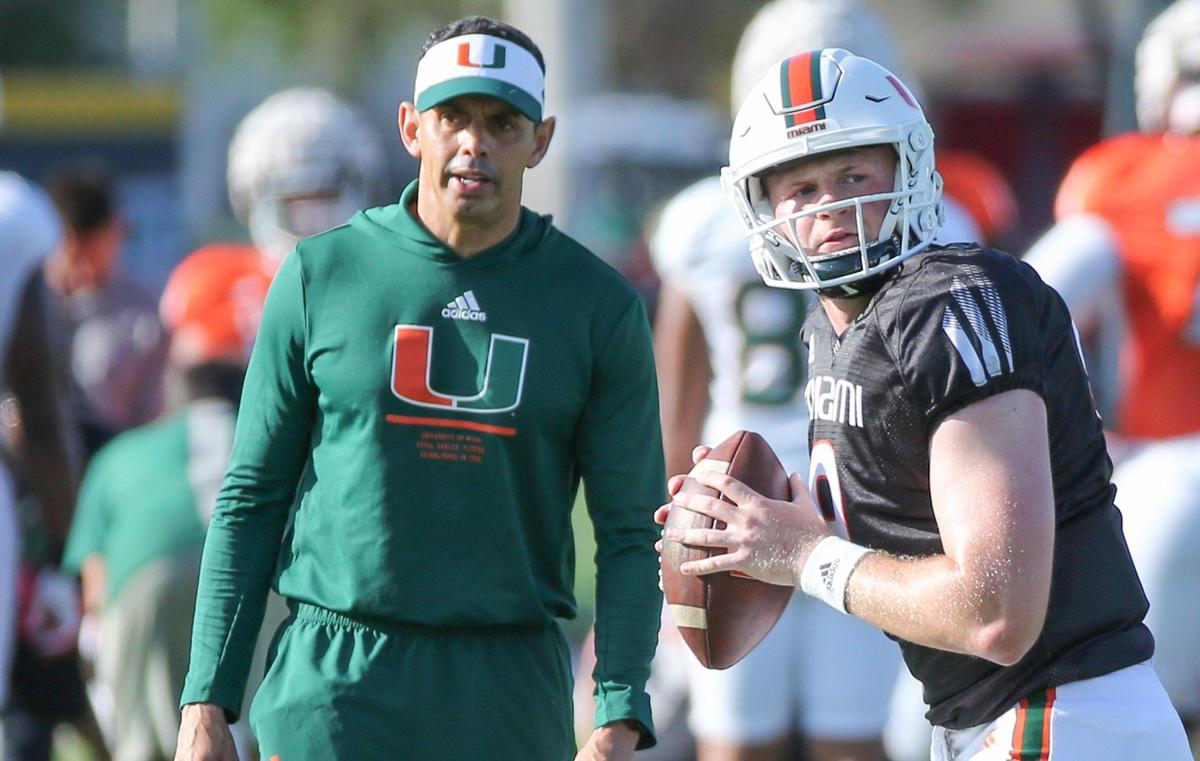 Miami Hurricanes quarterbacks and passing game coordinator Frank Ponce works with Tyler Van Dyke (9) during practice at the University of Miami’s Greentree Practice Field in Coral Gables on Tuesday, March 22, 2022.