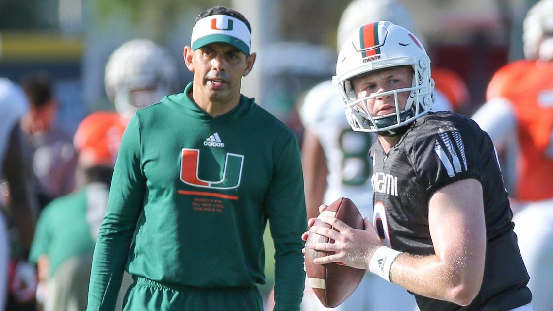 Miami Hurricanes quarterbacks and passing game coordinator Frank Ponce works with Tyler Van Dyke (9) during practice at the University of Miami’s Greentree Practice Field in Coral Gables on Tuesday, March 22, 2022.
