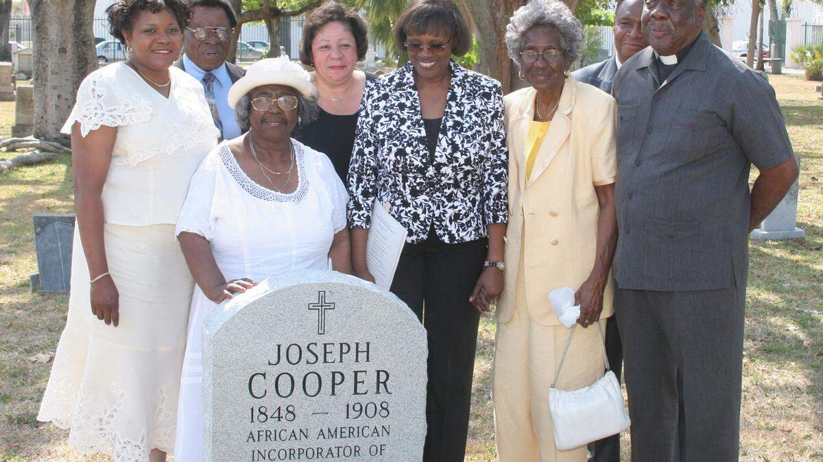 The unveiling of the headstone of Joseph Cooper at the city of Miami Cemetery. Front, Left to right, Audrey Edmonson, Enid Pinkney, Launita Gaiter, Theodora Cooper, Rev. Preston Marshal. Back, left-right, Rev. Robert Holt, Vickie Agustus- Fidelia, Rev. Jesse Marshall.