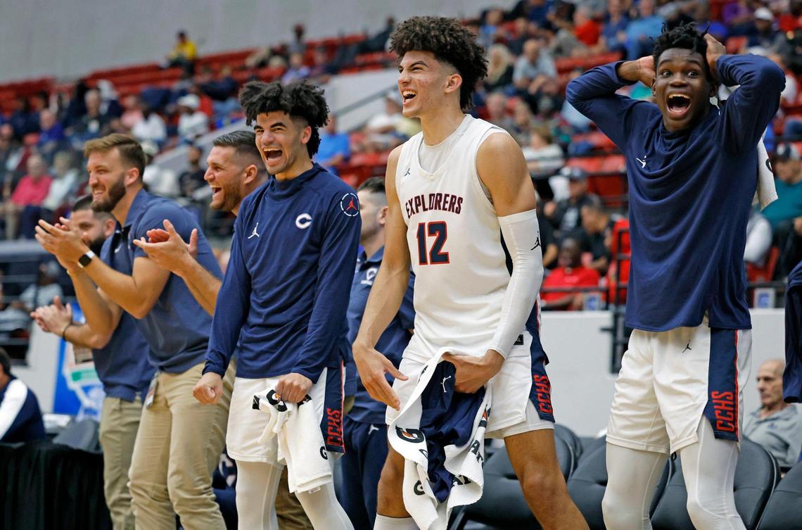 Columbus Explorers Cayden Boozer (2), Cameron Boozer (12) and Garyn Bess (11) celebrate a score in the final moments of the fourth quarter against Colonial High School during the FHSAA semifinal at the RP Funding Center in Lakeland, Florida on Friday, March 3, 2023.