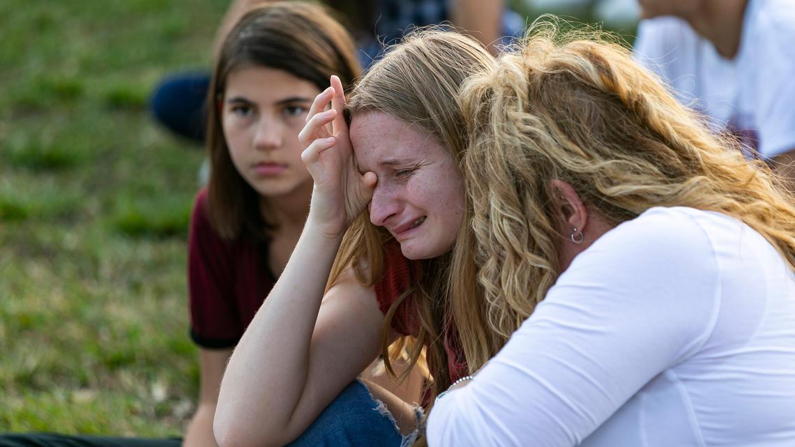 Maci Norkunas looks at a collage of art honoring the 17 victims killed at the Marjory Stoneman Douglas High School shooting. The art piece was on display at Pine Trails Park during the two-year anniversary of the shooting in Parkland, Florida on Feb. 14, 2020.