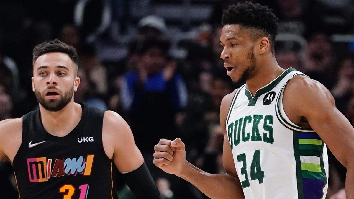Milwaukee Bucks’ Giannis Antetokounmpo reacts in front of Miami Heat’s Max Strus after making a basket and being fouled during the first half of an NBA basketball game Wednesday, March 2, 2022, in Milwaukee